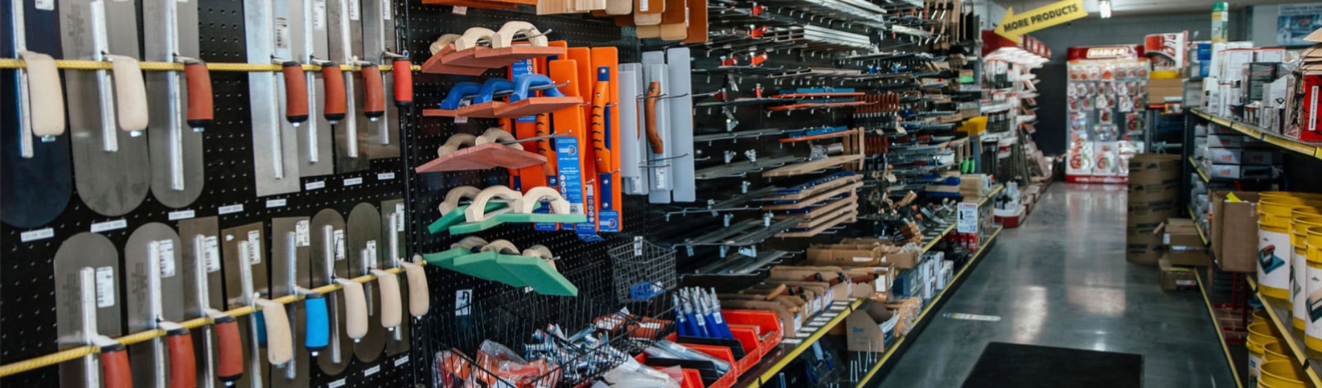 Store aisle with tools for shaping and smoothing concrete
